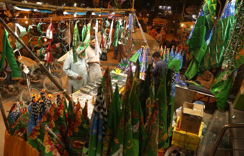 Shoppers buy decorative items on the roadside ahead of Eid-Milad-ul-Nabi, the birthday of Prophet Mohammed, in Karachi, Pakistan. EPA