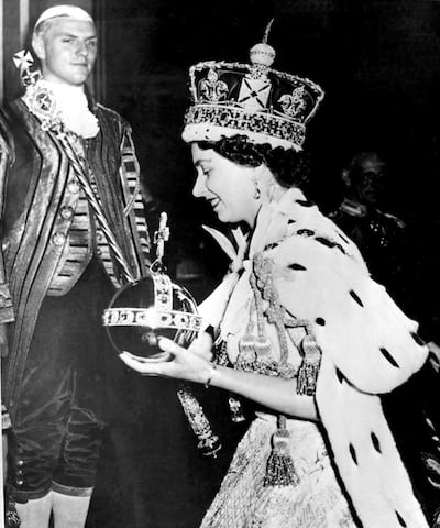 Queen Elizabeth II wearing the Imperial State Crown as she leaves Westminster Abbey, London, at the end of her coronation ceremony on June 2, 1953. AP