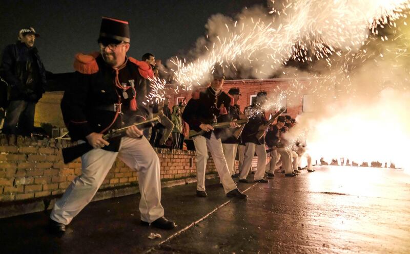 Participants dressed as Napoleonic soldiers put on a fire show. Olivier Hoslet / EPA