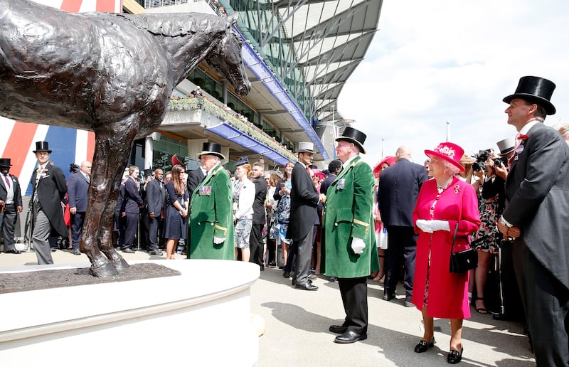 Alec Galloway, in the green coat to the right, with the queen for whom he had risked his life as a younger man. Photo: Tristan Fewings/Getty