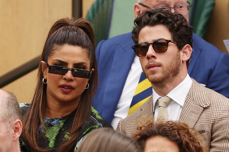Hollywood star Priyanka Chopra, left, and her husband and singer Nick Jonas attend the Wimbledon women's singles final at the All England Club on Saturday, July 15, 2023. AFP