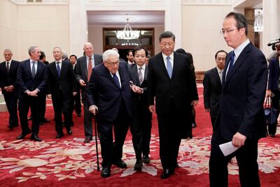 China's President Xi Jinping (centre R) and former US Secretary of State Henry Kissinger (centre L) walk to a meeting with delegates from the 2019 New Economy Forum at the Great Hall of the People in Beijing on November 22, 2019.  / AFP / POOL / JASON LEE
