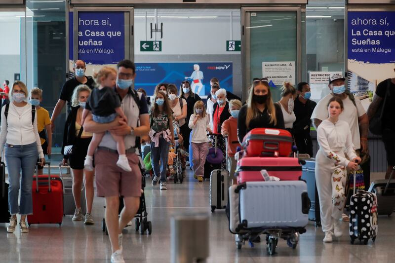 British tourists wearing protective face masks arrive at Malaga-Costa del Sol Airport in Spain. Reuters