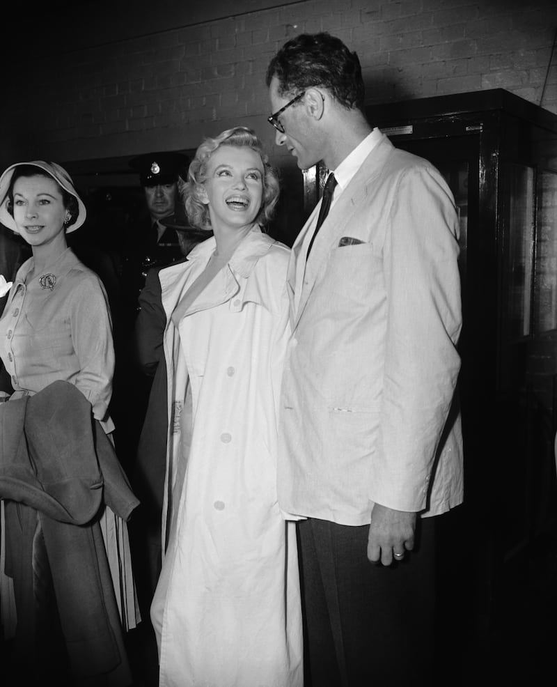 US film star Marilyn Monroe with her husband, playwright Arthur Miller, after arriving at the airport in July 1956
