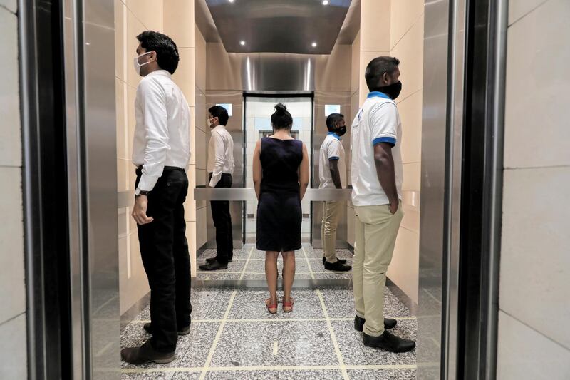 People practice social distancing inside an elevator as they head to their work places at World Trade Centre, after the government announced that private and state companies will reopen after almost two months of lockdown to contain the coronavirus, in Colombo, Sri Lanka. Reuters