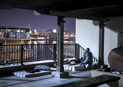 DUBAI, UNITED ARAB EMIRATES. 2 JUNE 2020. 
A man wakes his friend up in a park by Baniyas street in Deira. 
This park now homes around 20 people who have nowhere to stay, and no means to sustain themselves.

(Photo: Reem Mohammed/The National)

Reporter:
Section: