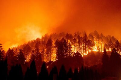 FILE - In this Sept. 27, 2020 file photo the Glass Fire burns a hillside above Silverado Trail in St. Helena, Calif. With months still to go in California's fire season, the state has already shattered records for the amount of land scorched in a single year, more than 4 million acres to date, with one blaze alone surpassing the 1 million-acre mark. Five of the 10 largest wildfires in state history have occurred since August. (AP Photo/Noah Berger, File)