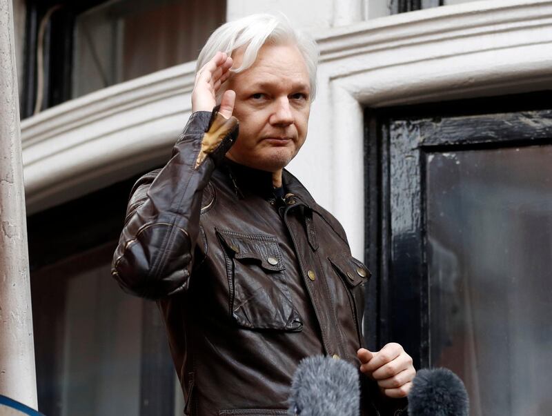 FILE - In this May 19, 2017 file photo, WikiLeaks founder Julian Assange greets supporters from a balcony of the Ecuadorian embassy in London. Ecuadorean officials announced Wednesday, March 28, 2018, that they are cutting off Assange's communications to the outside. Assange has been living in Ecuador's embassy for more than five years. (AP Photo/Frank Augstein, File)