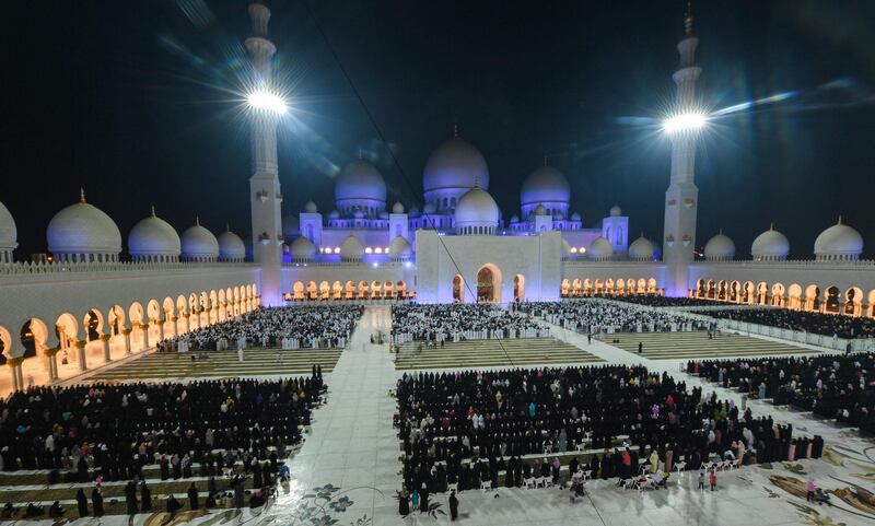Muslims pray in the courtyard of Sheikh Zayed Grand Mosque on the occasion of Laylat Al Qadr, which marks the night in the fasting month of Ramadan during which the Quran was first revealed to Prophet Mohammed in the seventh century.  Karim Sahib / AFP