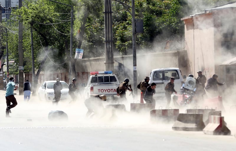 Security forces run from the site of a suicide attack after the second bombing in Kabul, Afghanistan. Massoud Hossaini / AP Photo