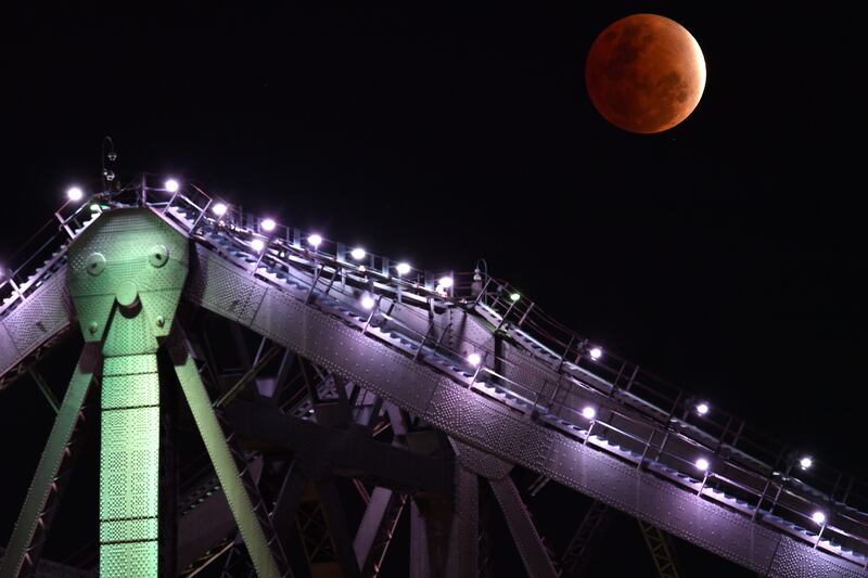 The view of Story Bridge in Brisbane as the Earth's shadow covers the Moon during a partial lunar eclipse. EPA