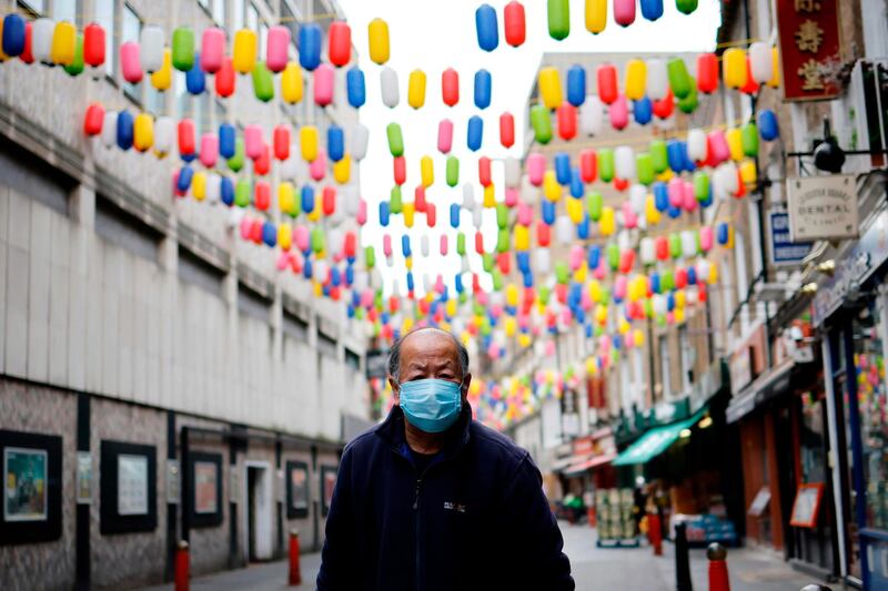 A man walks in London's China Town. British Prime Minister Boris Johnson on November 23 said the "escape route" from the coronavirus was in sight as he announced that tough restrictions  in England would not be extended beyond December 2. AFP