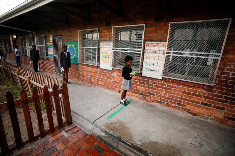 Learners observe social distancing markers as they queue at a school feeding scheme in Gugulethu township during a nationwide lockdown aimed at limiting the spread of coronavirus disease (COVID-19) in Cape Town, South Africa, April 24, 2020. Picture taken April 24, 2020. REUTERS/Mike Hutchings     TPX IMAGES OF THE DAY