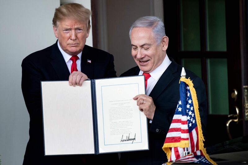 (FILES) In this file photo taken on March 25, 2019, US President Donald Trump (L) and Israel's Prime Minister Benjamin Netanyahu hold up a Golan Heights proclamation outside the West Wing after a meeting in the White House in Washington, DC. A peace plan with no chance of achieving peace: that's the paradox of Washington's proposal for an Israeli-Palestinian accord expected by January 28, 2020. A major obstacle to any such plan is that President Donald Trump has aligned himself so strongly with Israel, while repeatedly undercutting the Palestinian side, that in the eyes of the latter the US has lost its status as an "honest broker." The plan, described by the American president as "the ultimate deal," seeks to bridge major gaps between the Israeli and Palestinian sides, a goal that has eluded previous administrations reaching back for decades. Trump's son-in-law and adviser Jared Kushner began working on the proposal in 2017 in a largely secretive process.   / AFP / Brendan Smialowski / TO GO WITH AFP STORY by Francesco FONTEMAGGI, "Trump's anticipated Mideast peace plan may be short on peace"
