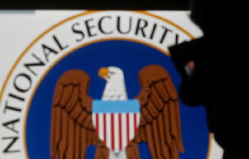 FILE PHOTO: A man is silhouetted near logo of the U.S. National Security Agency (NSA) in this photo illustration taken in Sarajevo March 11, 2015.  REUTERS/Dado Ruvic/File Photo