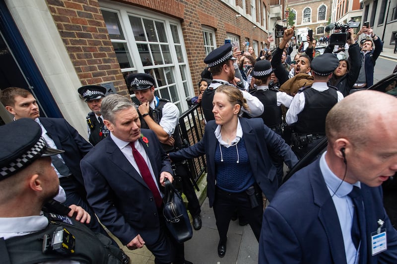 Labour Party leader Keir Starmer passes protesters after leaving Chatham House, where he delivered a speech on the situation in the Middle East. Getty Images