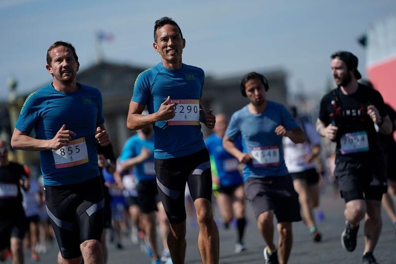 People run as they take part in the "Journee Olympique" ("Olympic day") in Paris, on June 23, 2019. A total of thirty Olympic and paralympic sports will be presented on Place de la Concorde in Paris.  AFP