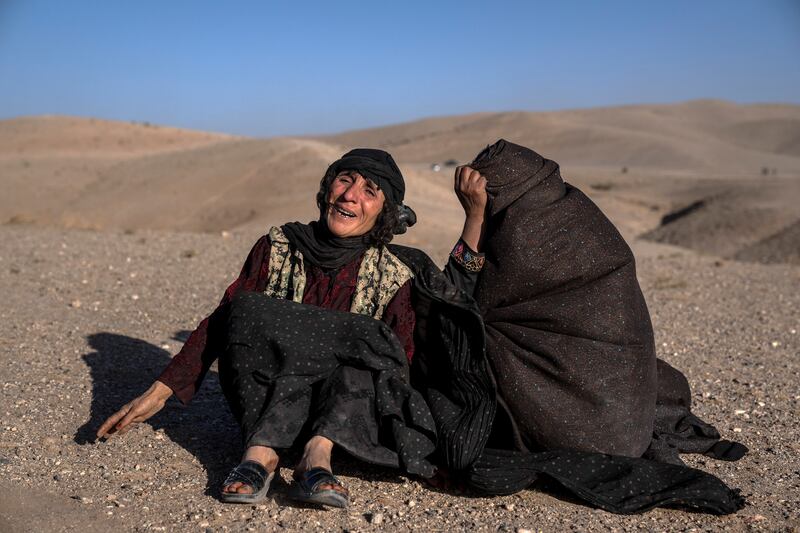 Afghan women mourn relatives killed in an earthquake at a burial site after an earthquake in Zenda Jan district in Herat province. AP