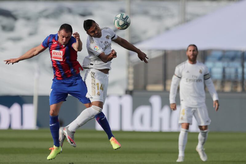 Real Madrid's Casemiro, right, and Kike Garcia battle for the ball. AP