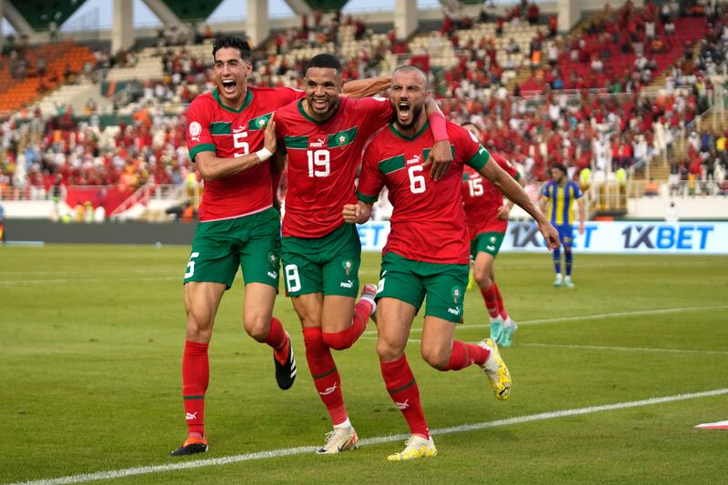 Morocco's Romain Saiss, right, celebrates with teammates after scoring his side's opening goal during the African Cup of Nations Group F soccer match between Morocco and Tanzania at the Laurent Pokou stadium in San Pedro, Ivory Coast, Wednesday, Jan.  17, 2024.  (AP Photo / Themba Hadebe)