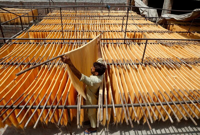 A vendor arranges traditional vermicelli noodles at a factory in Lahore, Pakistan. AP