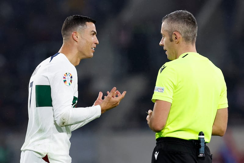 Portugal's Cristiano Ronaldo remonstrates with referee Radu Marian Petrescu. Reuters