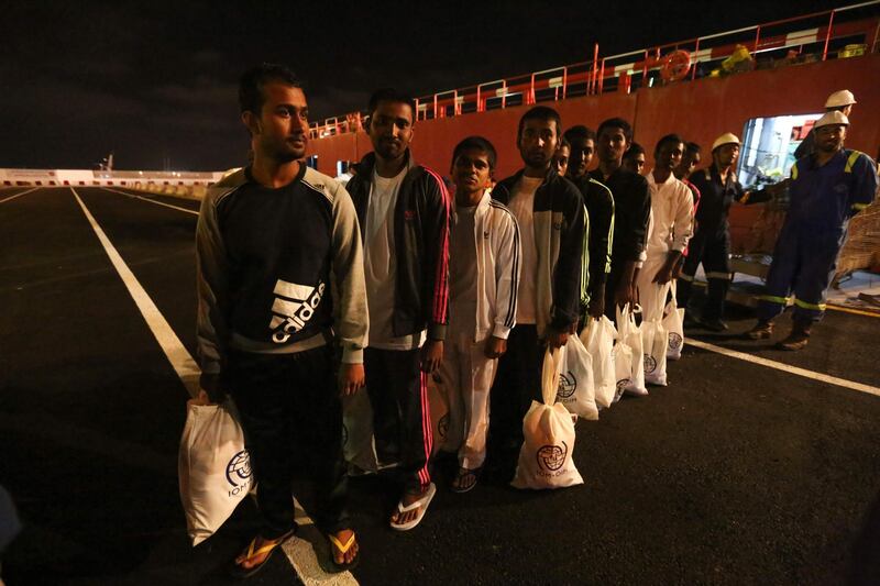 Migrants walk along the quay after disembarking from the vessel as they arrive to Zarzis harbour in the southern coast of Tunisia on June 18, 2019. 
 75 migrants rescued in the Mediterranean and stranded for two weeks off Tunisia will be allowed to disembark after accepting that they will be returned home, the Red Crescent said. The vessel has been anchored since May 31 off the southern port of Zarzis, where authorities have refused to allow the vessel to dock despite an appeal by the boat's captain. / AFP / FATHI NASRI
