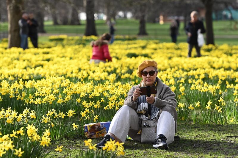 People enjoy spring-like weather at a park in London. British Prime Minister Boris Johnson has set out his roadmap for easing lockdown restrictions with a raft of new freedoms coming into place June 21. EPA