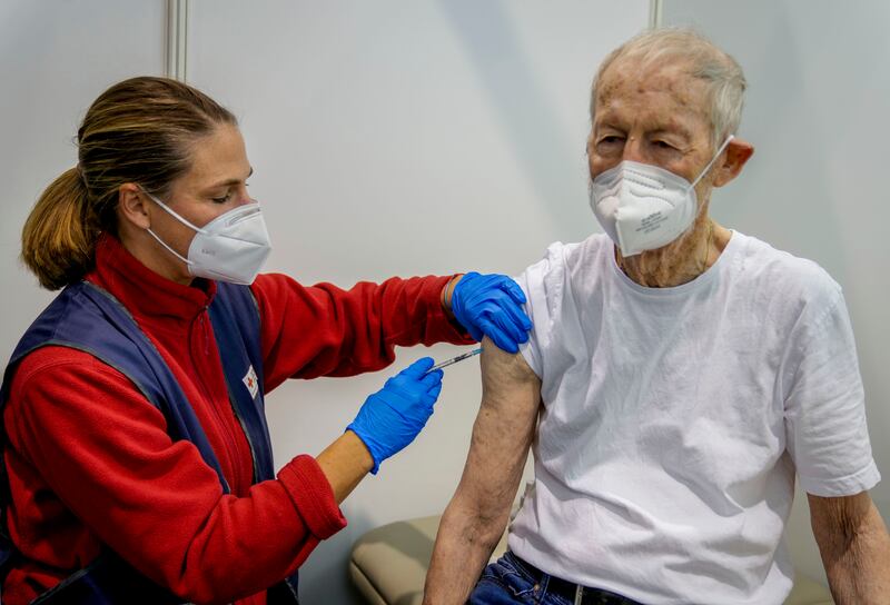 A man, 87, receives his booster shot at a vaccination centre in Frankfurt. AP Photo