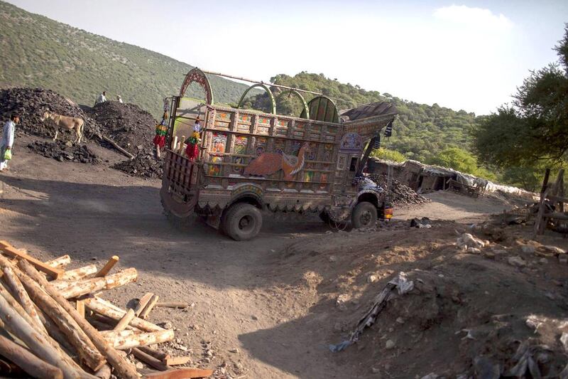 A truck drives past a coal field in Choa Saidan Shah, Punjab. Sara Farid / Reuters