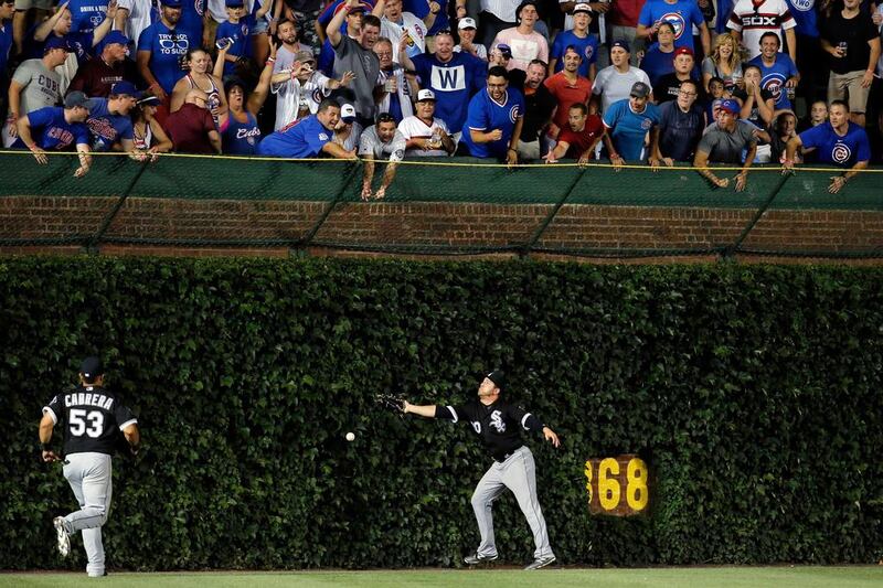 JB Shuck of the Chicago White Sox is unable to make a catch from a hit by Ben Zobrist 8 of the Chicago Cubs.  Jon Durr / Getty Images / AFP