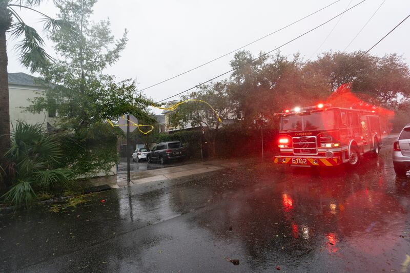 Firefighters mark low-hanging wires after Hurricane Ian barrels through Charleston. AP