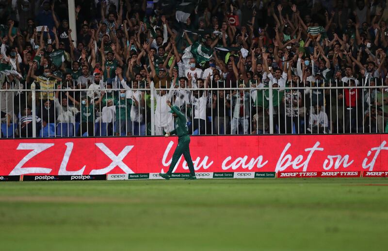 Pakistan's fans celebrate as captain Babar Azam takes a catch to dismiss New Zealand's Devon Conway. AP
