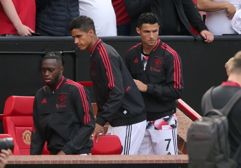 Manchester United's Cristiano Ronaldo, right, takes his seat on the bench. PA