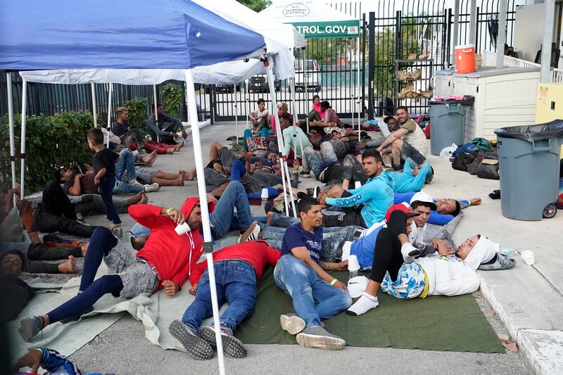 Recently arrived migrants wait in a garage area of the US Customs and Border Protection - Marathon Border Patrol Station in Florida. AP