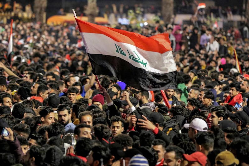 Fans celebrate in the centre of Baghdad on Thursday after Iraq defeated Oman to win the Arabian Gulf Cup. AFP