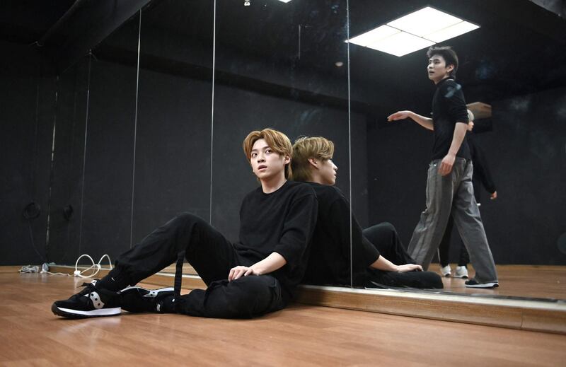 Blitzers member Jang Jun-ho, left, taking a break during a dance practise session at a rehearsal studio in Seoul. AFP