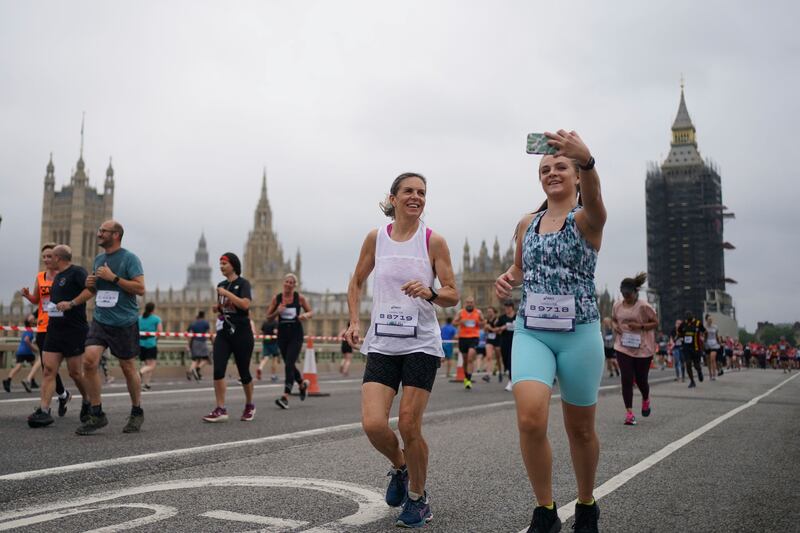 Participants run across Westminster Bridge in London during the Asics London 10km marathon.