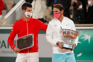 FILE PHOTO: Tennis - French Open - Roland Garros, Paris, France - October 11, 2020 Runner up Novak Djokovic of Serbia alongside French Open winner Rafael Nadal of Spain as they are presented with their trophies after the final REUTERS/Charles Platiau/File Photo