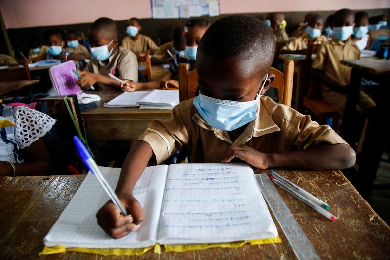 Students wear protective masks in a classroom at a school where a number of cases of the Omicron variant have been detected, in Abidjan, Ivory Coast. Reuters