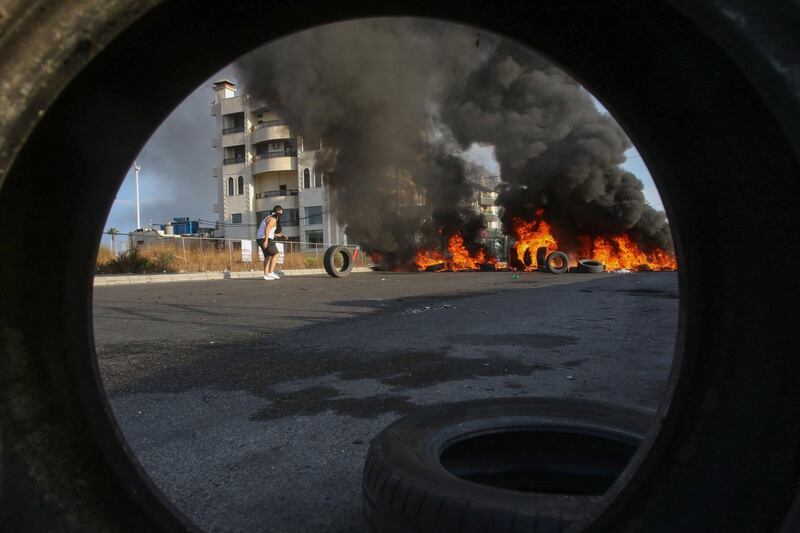 Lebanese protesters block a road with burning tires during ongoing anti-government demonstrations in the southern coastal city of Saida (Sidon). AFP