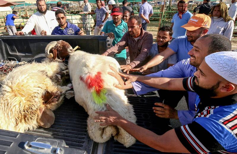 Kuwaitis purchase sheep at a livestock market in Kuwait City.  AFP