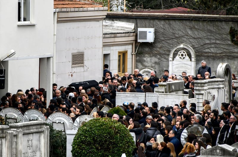 A crowd gathers as Ms Hananel's coffin is carried through the  Arnavutkoy Jewish cemetery in Istanbul. Stringer / AFP Photo.