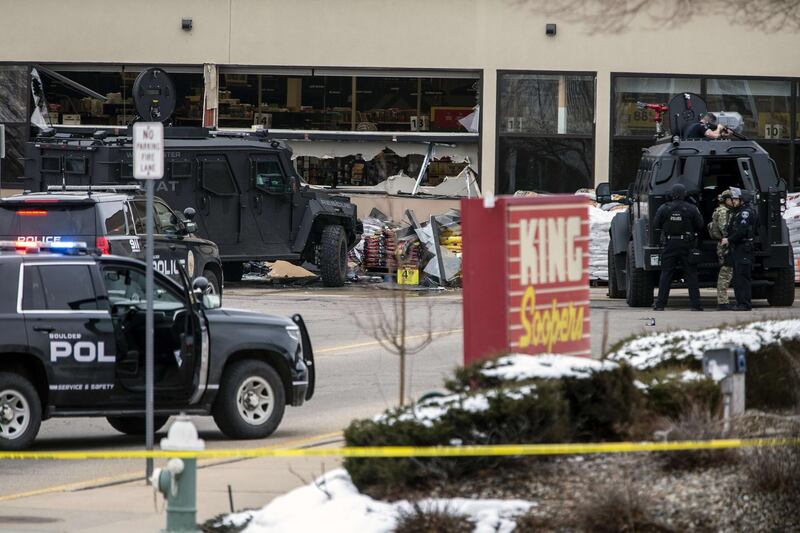 Smashed windows are left at the scene after a gunman opened fire at a King Sooper's grocery store. AFP
