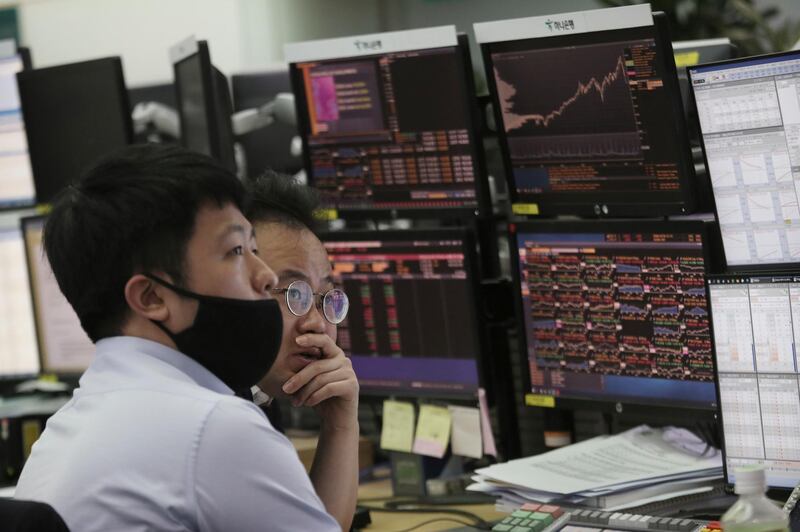 Currency traders watch monitors at the foreign exchange dealing room of the KEB Hana Bank headquarters in Seoul, South Korea, Tuesday, March 10, 2020. Asian stock markets are taking a breather from recent declines. (AP Photo/Ahn Young-joon)