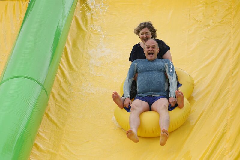 Mr Davey and Anna Sabine, parliamentary candidate for Frome and East Somerset, ride the Ultimate Slip 'n' Slide at Eastcote Farm in Beckington. Bloomberg