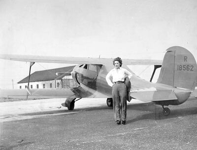 UNITED STATES - AUGUST 19:  Pilot Jacqueline (Jackie) Cochran, wife of millionaire Floyd B. Odlum, next to her Beechcraft biplane. She is shown at Roosevelt Field just before taking off for the West to compete in the Bendix Trophy Races in Cleveland.  (Photo by Drennan/NY Daily News Archive via Getty Images)