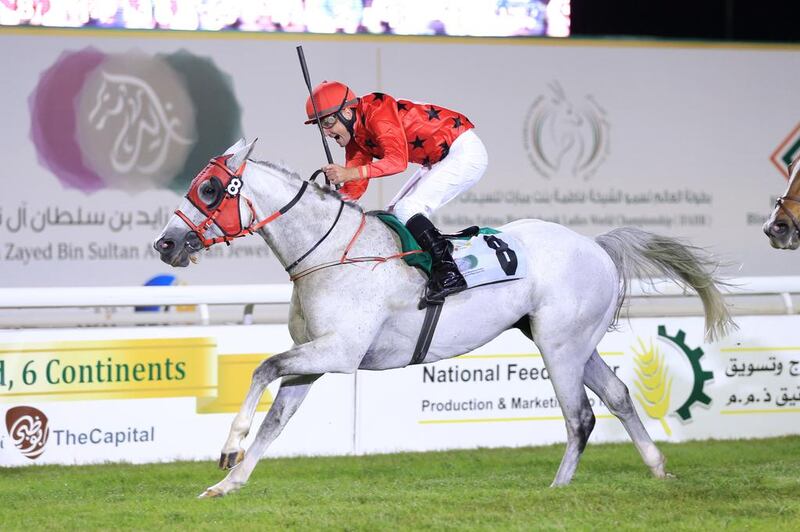 RB Burn, ridden by jockey Gerald Avranche, is in action at the Abu Dhabi Equestrian Club on Sunday. Erika Rasmussen for The National