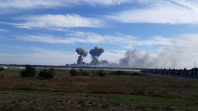 Smoke rises after explosions at a Russian air and naval base in Crimea. Reuters