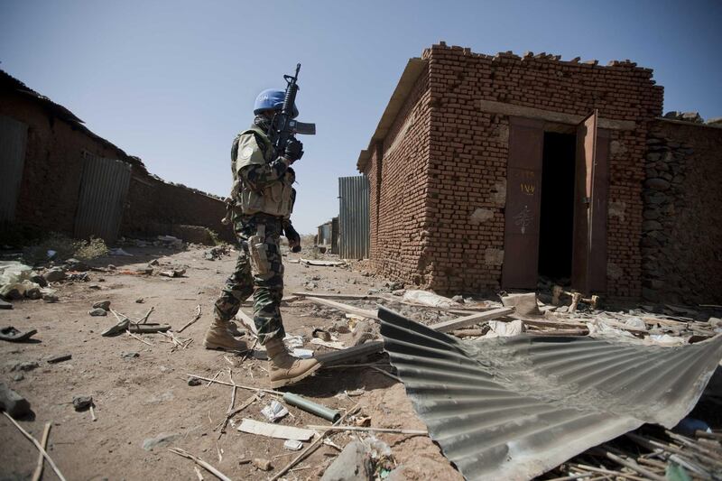 EDITORS NOTE ---- RESTRICTED TO EDITORIAL USE - MANDATORY CREDIT "AFP PHOTO / HO / UNAMID" NO MARKETING NO ADVERTISING CAMPAIGNS - DISTRIBUTED AS A SERVICE TO CLIENTS
A handout picture released by the United Nations and African Union Mission in Darfur (UNAMID) shows a peacekeeper from the Nepalese Special Forces patrols in Jawa village, in East Jebel Marra (South Darfur) on March 18, 2011 the area is controled by the Government Forces but most of the population fled some days ago due to the clashes. AFP PHOTO/HO/UNAMID/ALBERT GONZALEZ FARRAN (Photo by ALBERT GONZALEZ FARRAN / UNAMID / AFP)